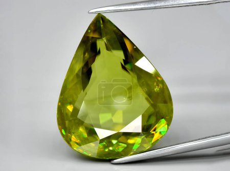 Photo for Natural green sphene titanite gem on background - Royalty Free Image