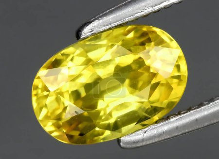 Photo for Natural yellow chrysoberyl gem on background - Royalty Free Image