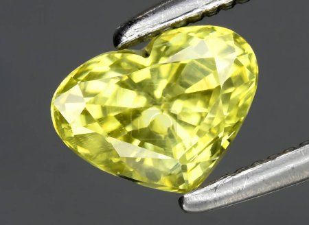 Photo for Natural yellow chrysoberyl gem on background - Royalty Free Image