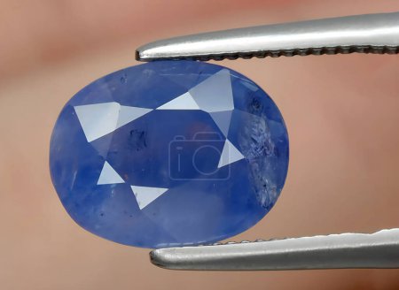 Natural blue sapphire gem on background