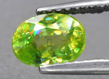 Photo for Natural green sphene gem on background - Royalty Free Image