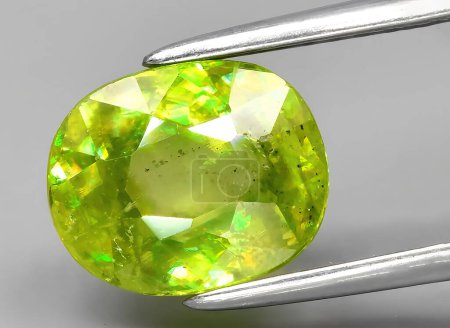 Photo for Natural green sphene gem on background - Royalty Free Image