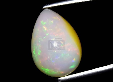 Téléchargez les photos : Gemme d'opale arc-en-ciel multicolore naturelle sur fond - en image libre de droit