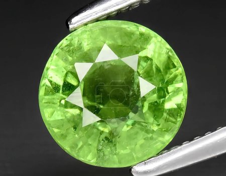 Photo for Natural green grossular garnet gem on background - Royalty Free Image
