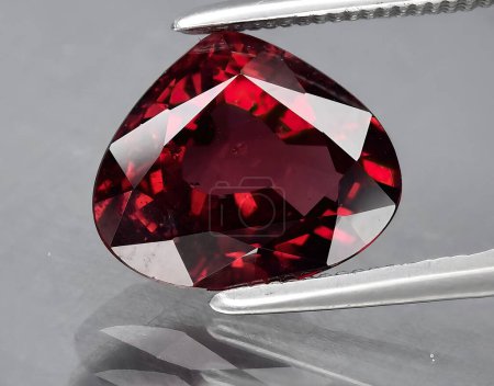 Photo for Natural red purplish rhodolite garnet gem on background - Royalty Free Image