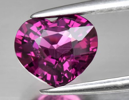 natural pink purple rhodolite garnet gem on background