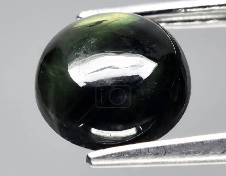 Photo for Natural dark green sapphire gem on background - Royalty Free Image