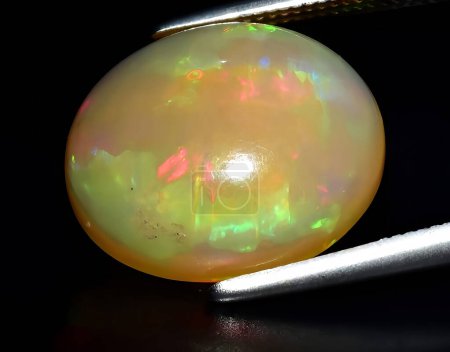natural rainbow multi color opal gem on background