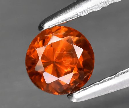 natural orange hessonite garnet gem on background