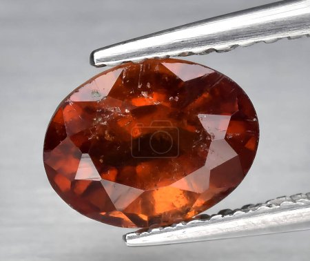 natural orange hessonite garnet gem on background