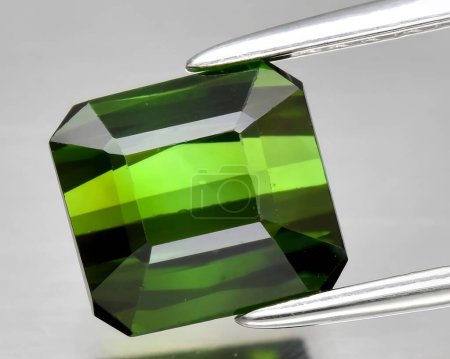 natural green tourmaline gem on background