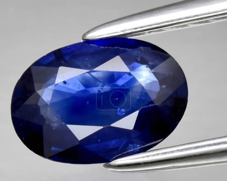 natural dark blue sapphire gem on background