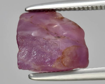 natural red ruby rough gem on background