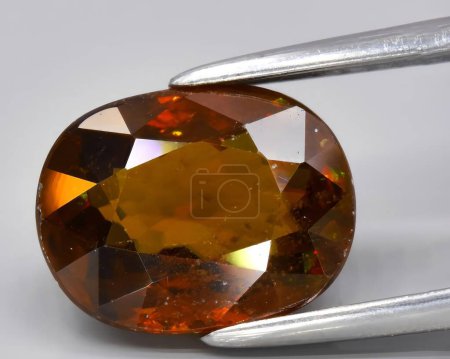 natural brown sphene titanite gem on background