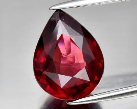 natural red rhodolite garnet gem on background