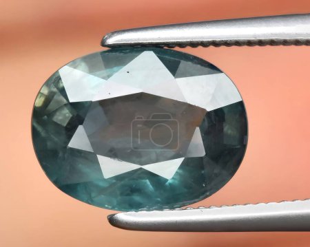natural blue green sapphire gem on background