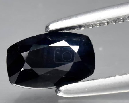natural dark blue sapphire gem on background