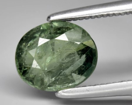 Photo for Natural dark green sapphire gem on background - Royalty Free Image