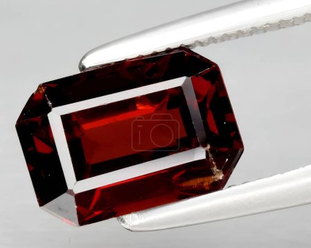 natural red spessartite garnet gem on background