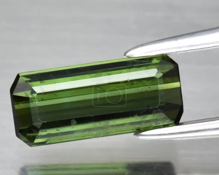 natural green tourmaline gem on background