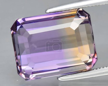 natural bi color yellow purple ametrine quartz gem on background