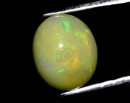 natural multi color rainbow opal gem on background