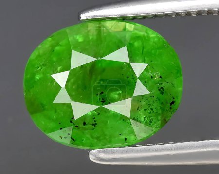 natural green grossular garnet gem on background