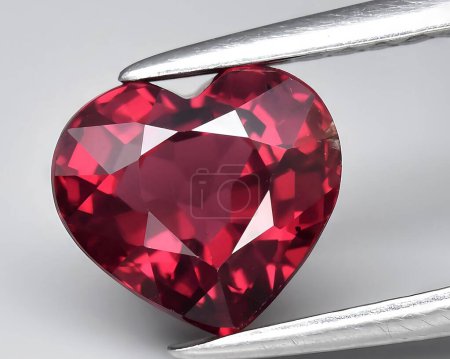 natural pink red rhodolite gem on background