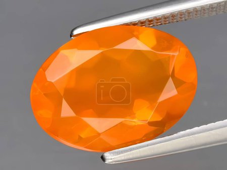natural orange fire opal gemstone on background