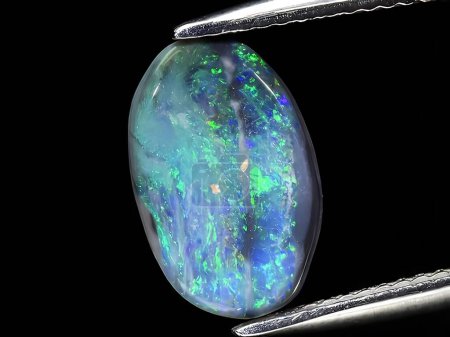 natural rainbow multi color opal gemstone on background
