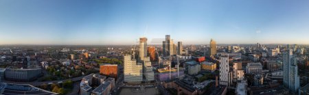 Photo for Wide panorama of Manchester cityscape with the urban skyline extending into the horizon during the golden hour - Royalty Free Image