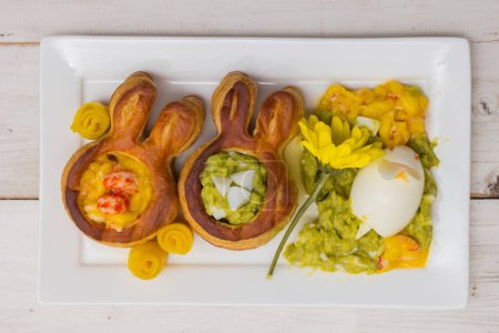 Puff pastry vol-au-vents shaped like an easter bunny filled with mango and avocado mousse