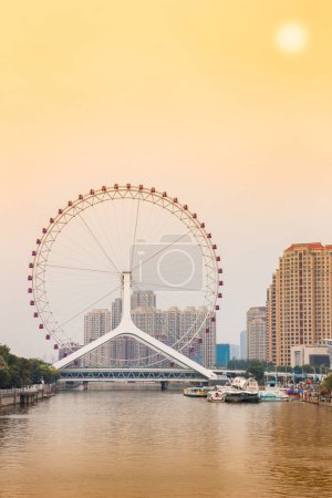 Sunset over the Tianjin Eye ferris wheel in Tianjin, China
