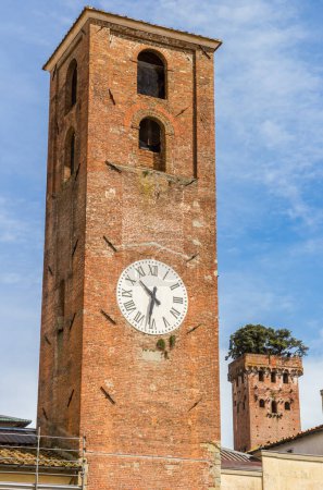 Clock tower and Guinigi tower in Lucca, Italy