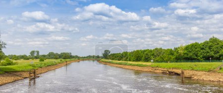 Panorama of a cascade flowing into the Ems river near Papenburg, Germany