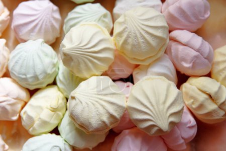 Marshmallow production. Fresh, sweet, multi-coloured marshmallows just cooked at a confectionery factory are sent for packing