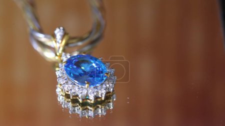 Photo for Beautiful necklace with blue sapphires on a golden light background. - Royalty Free Image
