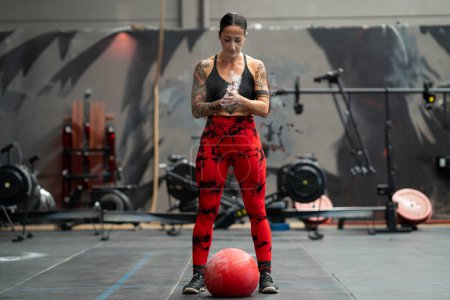 Photo for Strong woman ready to use a medicinal ball in a cross training gym - Royalty Free Image