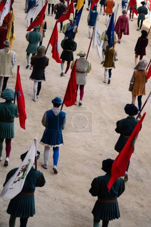 Photo for Siena, Italy - August 17 2022: Corteo Storico of the Palio di Siena, Men Bearing the Insignia of the City, called Potesteria, wearing Traditional Clothing Costumes and Flags for the Historical Parade of the Medieval Horse Race - Royalty Free Image