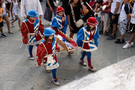 Photo for Siena, Italy - August 14 2022: Girls of the Pantera or Panther Contrada Carrying Cero Votivo Candles at the Procession before the Palio. - Royalty Free Image