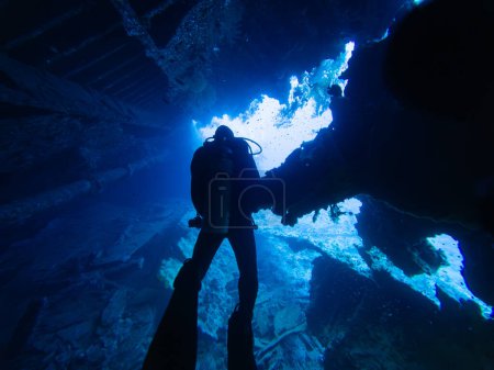 Diver inside the Wreck of Steamship SS Dunraven Sunk at Shaab Mahmoud Reef in the Red Sea, Egypt