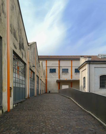 Photo for Industrial area of Milan now restructured. Courtyard with nobody inside - Royalty Free Image