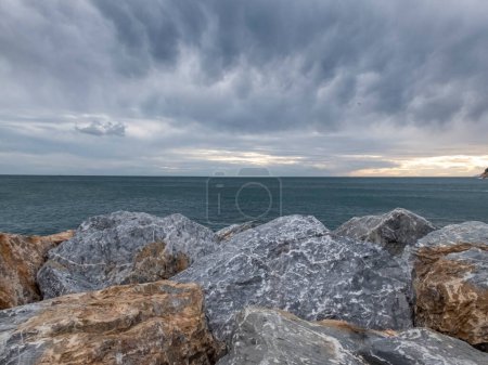 Photo for Sunrise and horizon with stones in foreground, Italy - Royalty Free Image