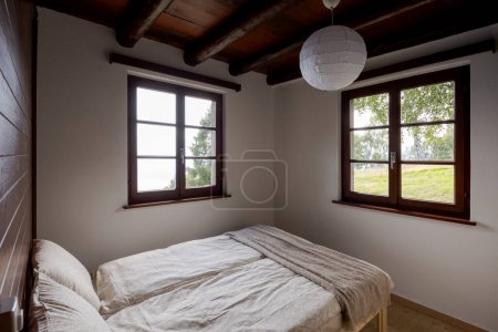 Photo for Interior of an old-style bedroom in a mountain chalet in Switzerland - Royalty Free Image