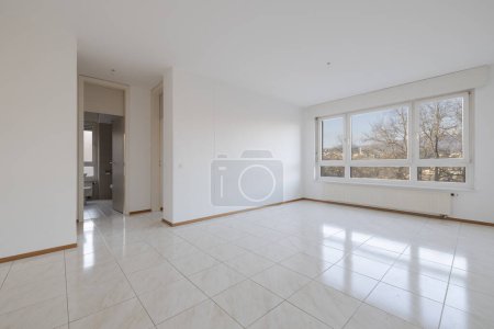 Photo for Empty living room with large bright window with a radiator underneath. Nobody inside - Royalty Free Image