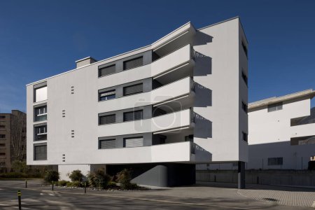 Photo for Modern condominium painted white with very particular protruding balconies. Residential neighborhood in Switzerland. Nobody inside - Royalty Free Image
