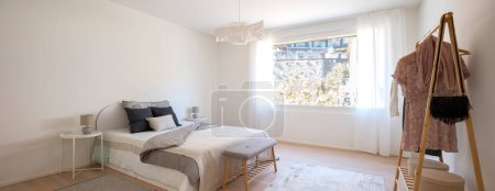 Photo for Bedroom interior with bed and large window. No people inside. These are modern rooms with white walls in the floor a carpet. - Royalty Free Image