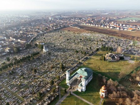 Drone view of the Catholic church and cemetery on the sunrise. Sombor, Serbia, Europe