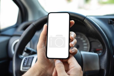 Photo for Men hands hold phone with isolated screen background of steering wheel in the car - Royalty Free Image
