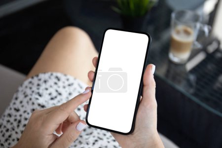 Photo for Woman hand hold phone with isolated screen background of cafe office - Royalty Free Image
